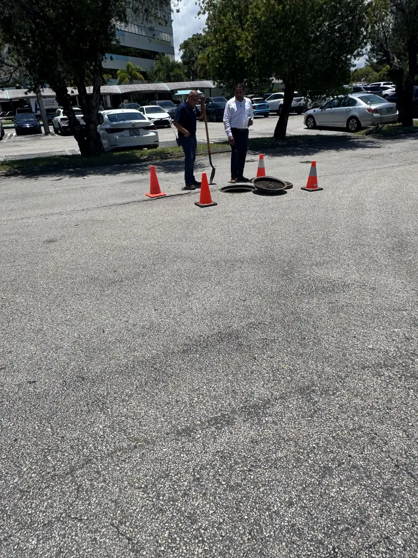 Coned-off manhole on a commercial sewer job