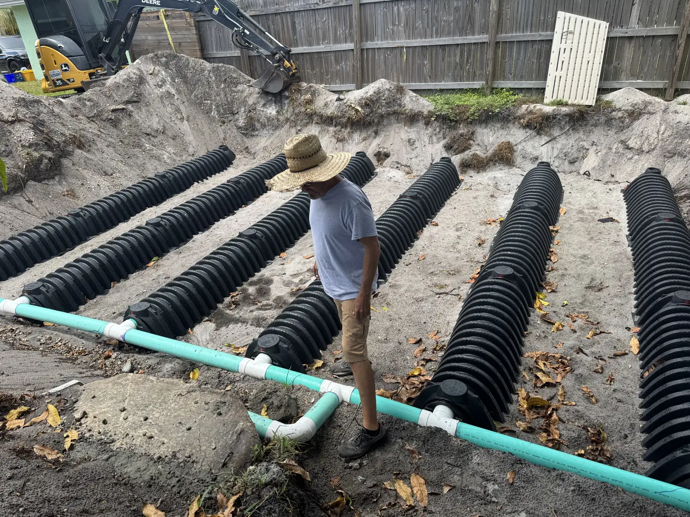 Tech walking the chamber rows of a new drain field