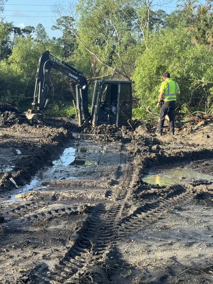 Excavator working a wet septic site