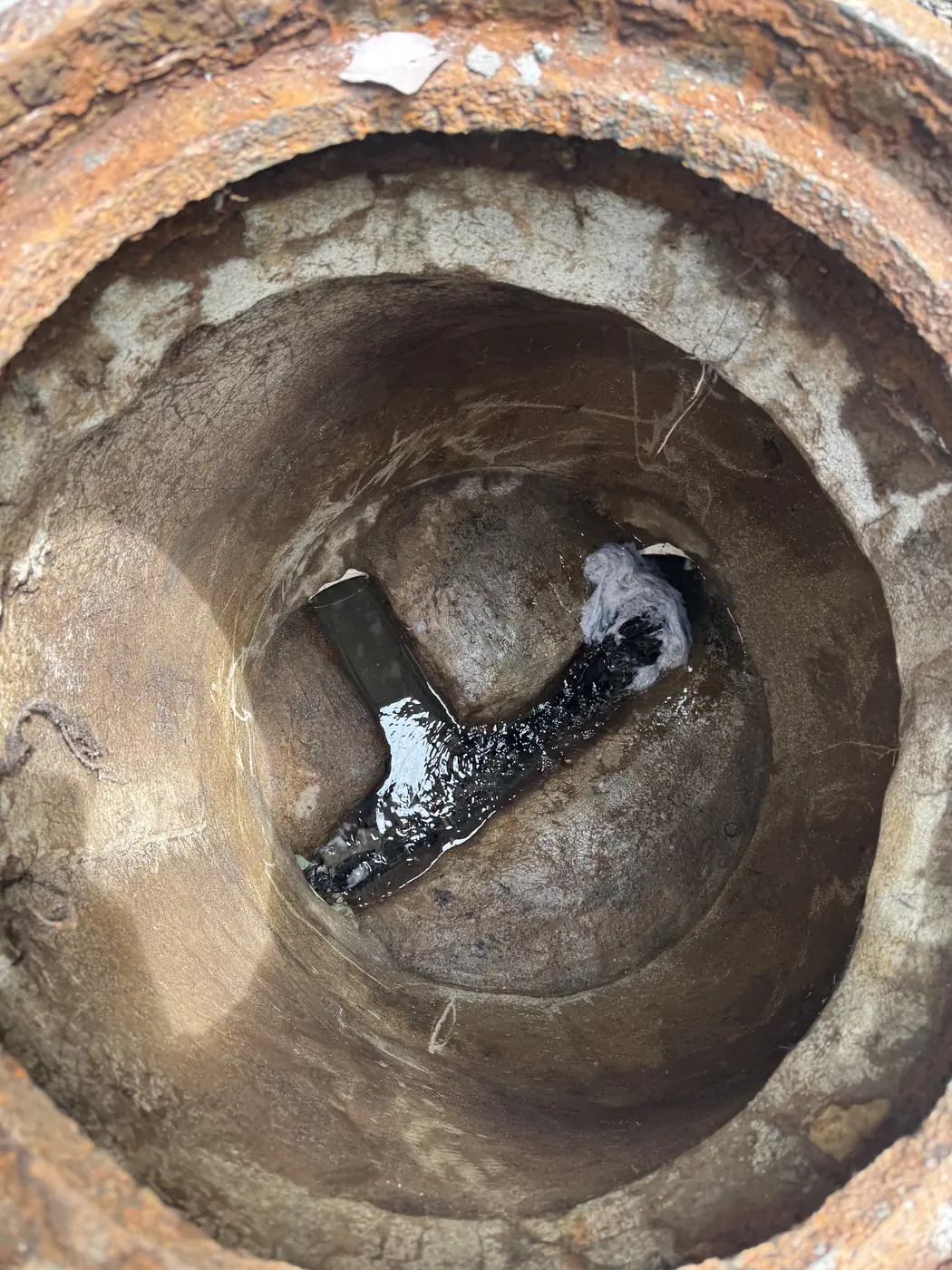Outlet tee inside a concrete septic tank