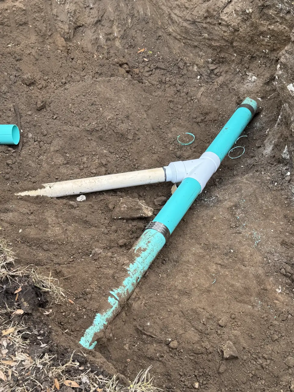 New PVC line and tee running to the septic tank