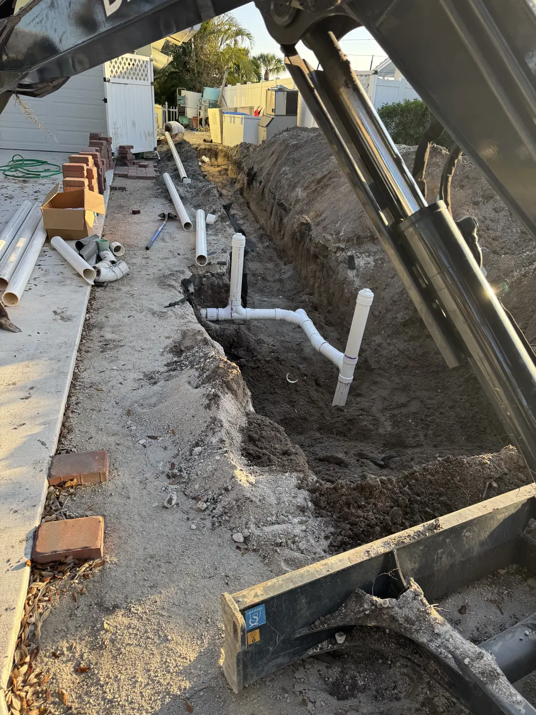 Trench and new piping beside a home