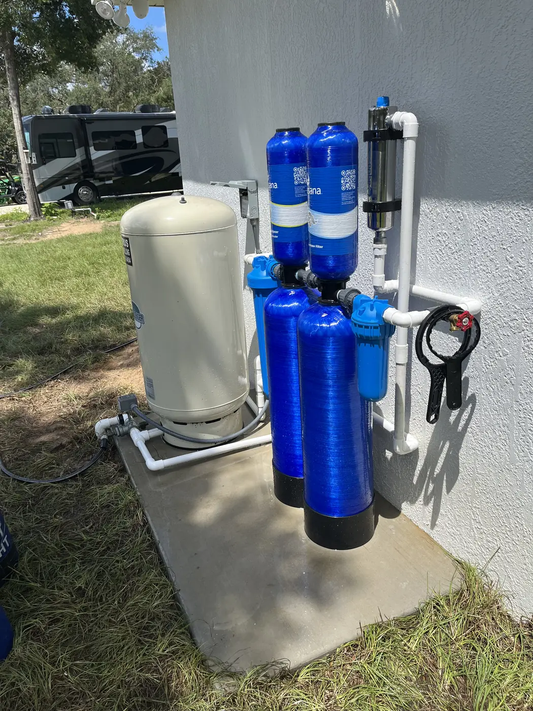Whole-home water filtration with a relocated well bladder tank